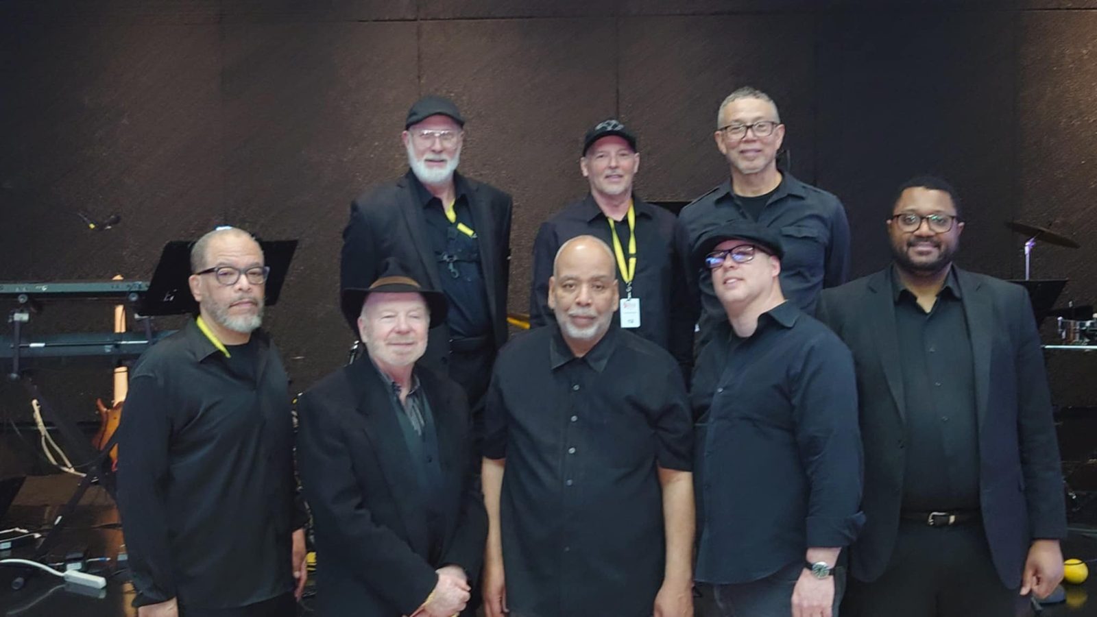 The eight members of the State Streets Band, dressed in black, on stage